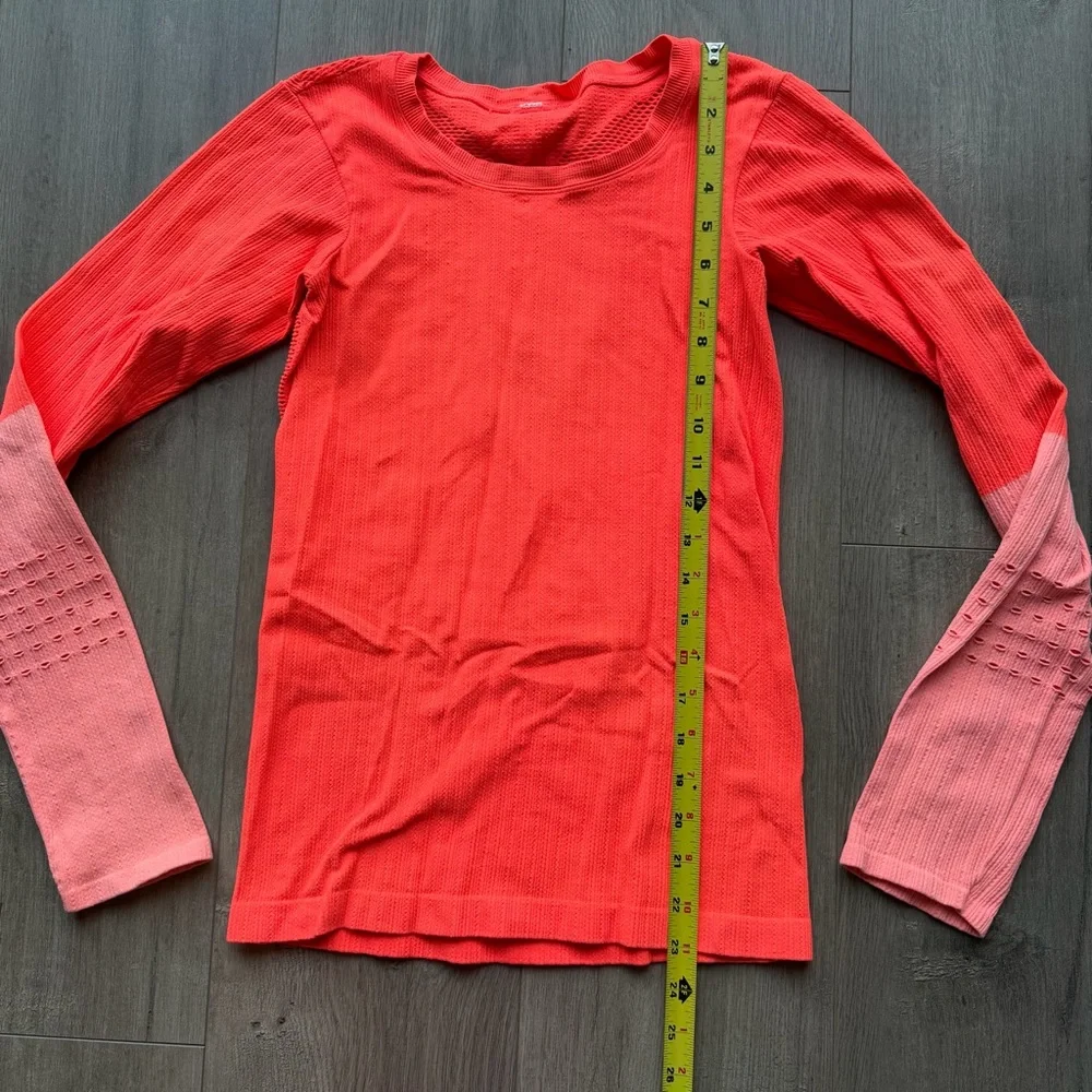 EUC Alo Yoga Exhale long sleeve top in neon orange/light pink